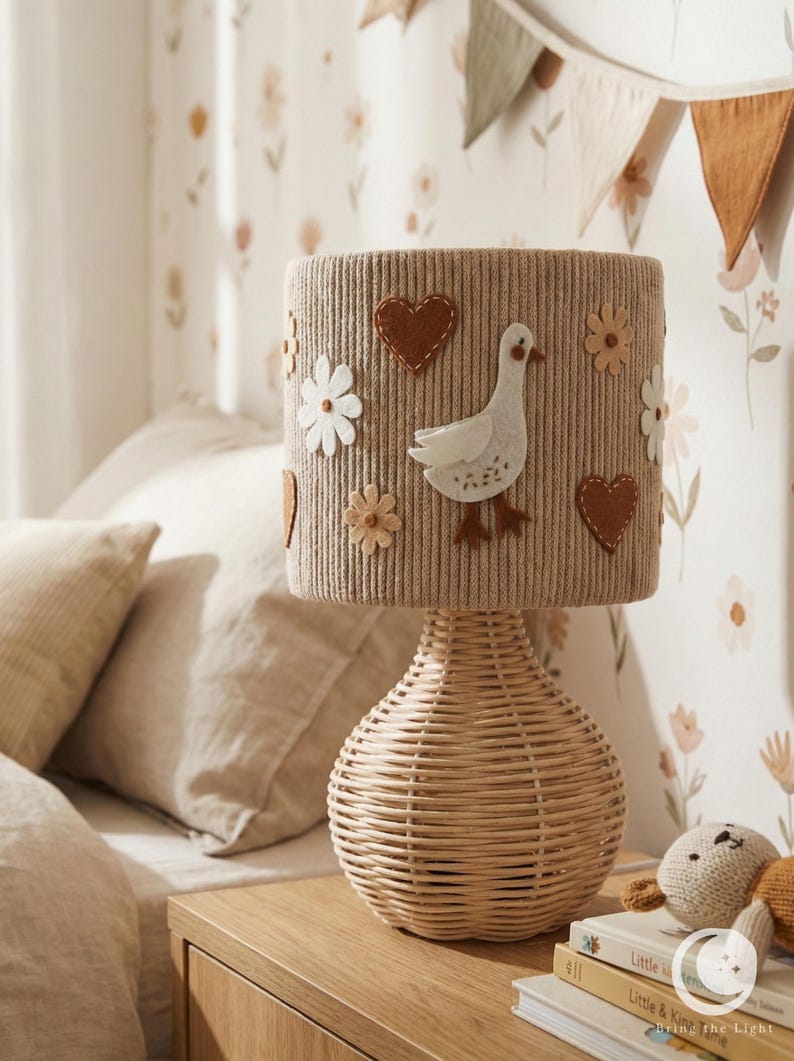 Goose Lamp with a felt bird, flowers and hearts above a rounded woven base
