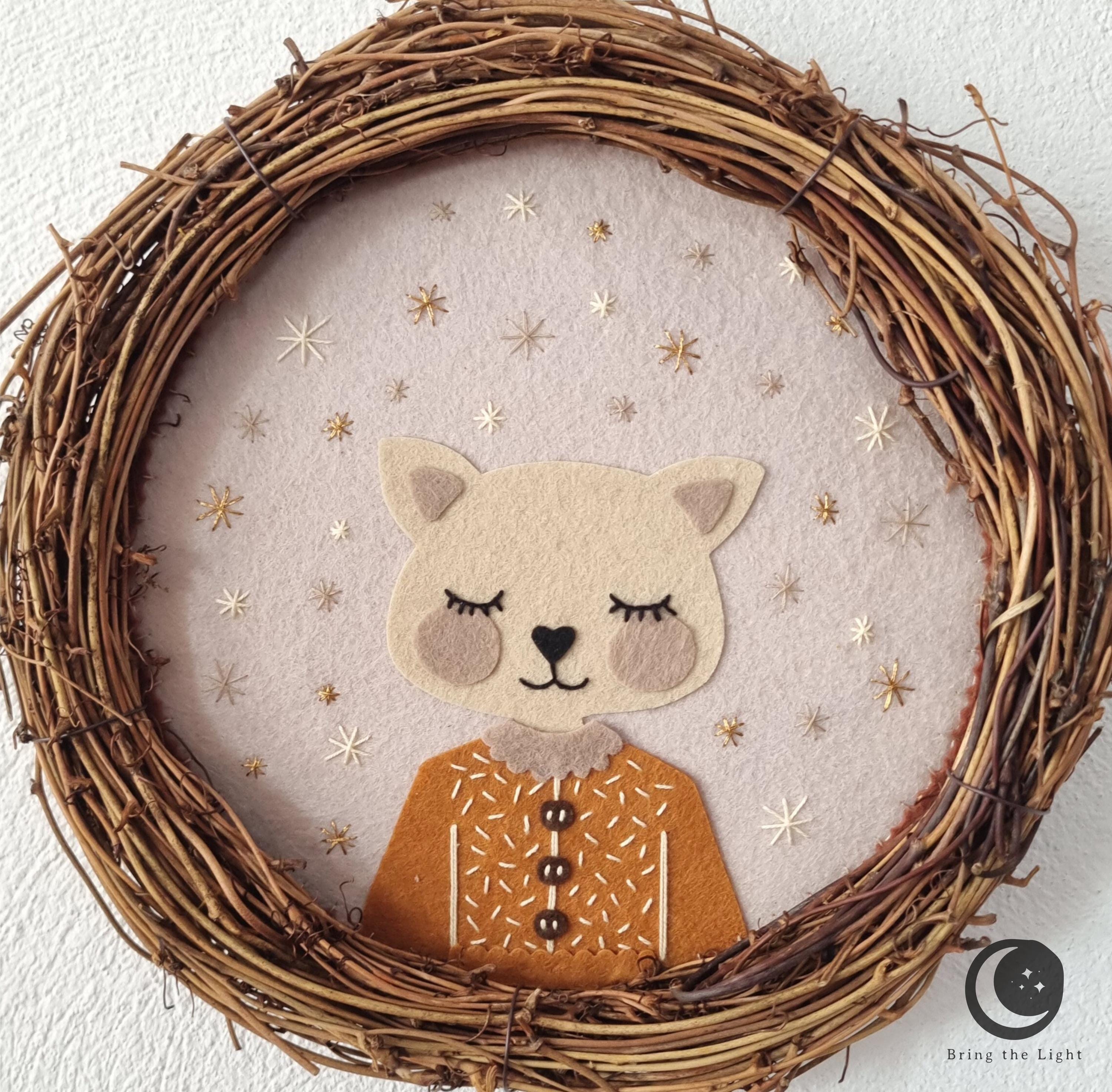 Handmade felt cat wall wreath in boho nursery tones