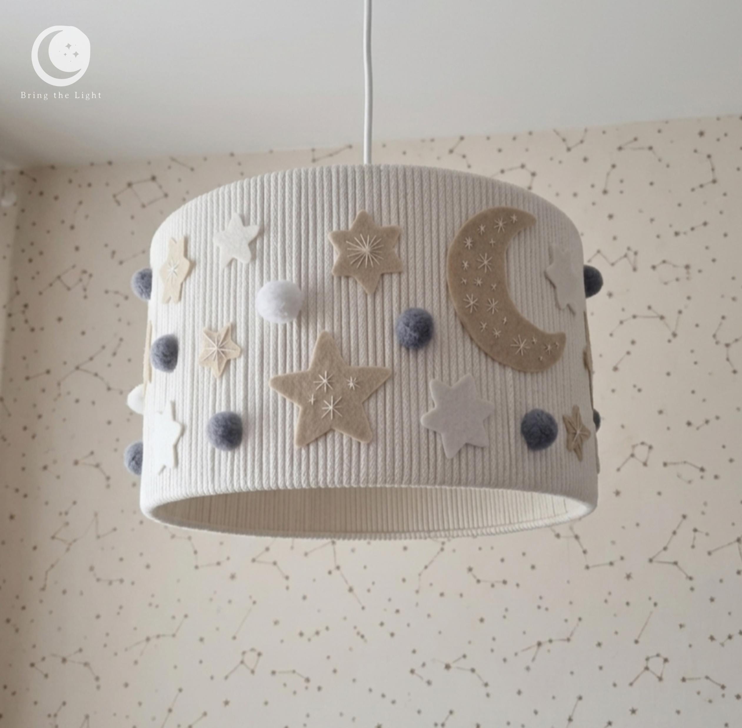 Handmade Night Sky nursery ceiling lamp with felt moons, stars, and pom-poms