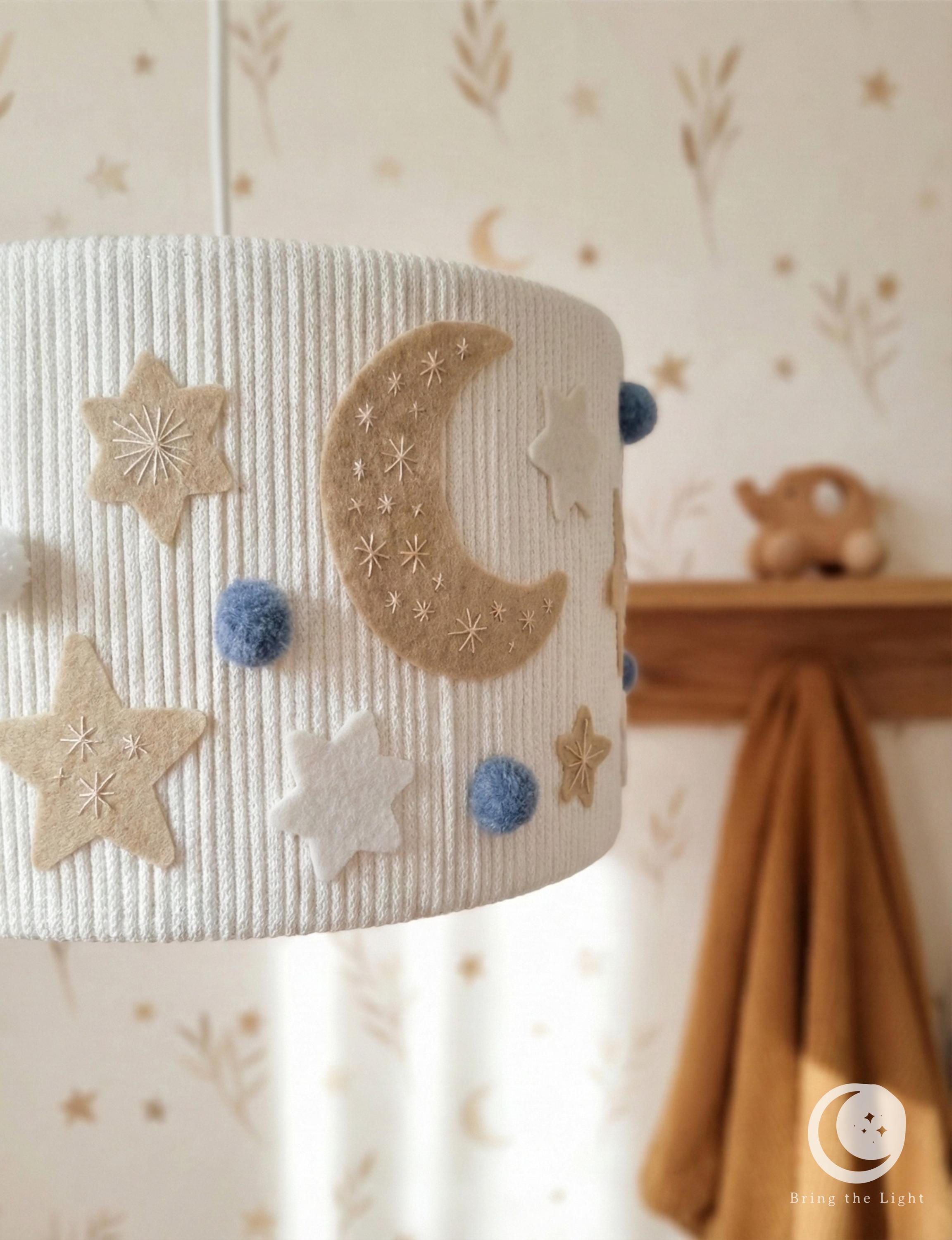 Handmade Night Sky nursery ceiling lamp with felt moons, stars, and pom-poms