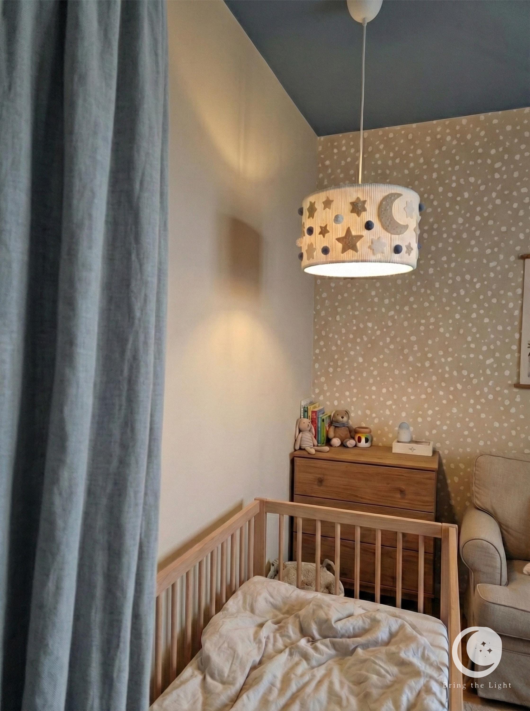 Handmade Night Sky nursery ceiling lamp with felt moons, stars, and pom-poms